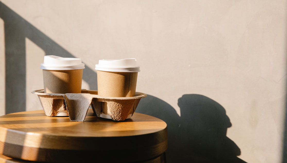 Two disposable coffee cups in a coffee carrier