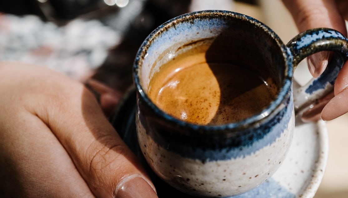 Woman Holding a Cup of Espresso