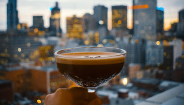 Espresso martini with a city in the background