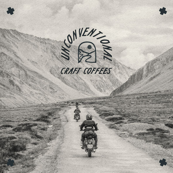 unconventional craft coffees over image of motorcycle riders in the desert