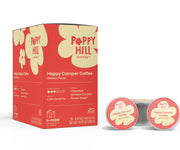Poppy Hill Coffee Happy Camper Coffee pods and packaging on a white background