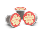 Three Happy Camper Coffee capsules on a white background