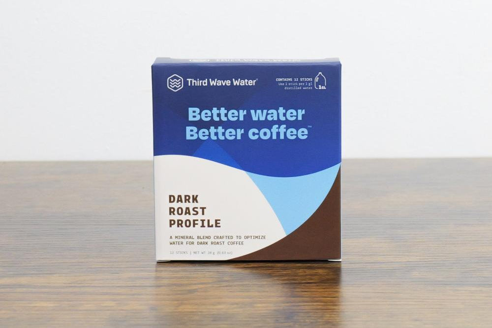 Third Wave Water packaging with a blue and brown design on a wooden surface.