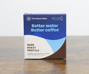 Third Wave Water packaging with a blue and brown design on a wooden surface.