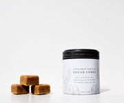 Cinnamon vanilla sugar cubes with packaging on a white background